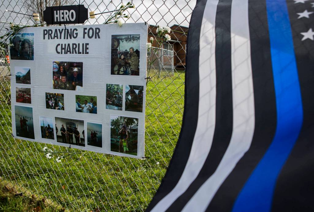 A poster board with photographs of Charlie Cortez at a memorial at the Tulalip Marina on Wednesday. (Olivia Vanni / The Herald)
