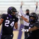 Washingtons Kamari Pleasant (24) celebrates his touchdown with Terrell Bynum during the second half of a game against Arizona on Nov. 21, 2020, in Seattle. (AP Photo/Elaine Thompson)