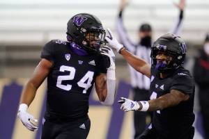 Washington's Kamari Pleasant (24) celebrates his touchdown with Terrell Bynum against Arizona during the second half of an NCAA college football game Saturday, Nov. 21, 2020, in Seattle. (AP Photo/Elaine Thompson)