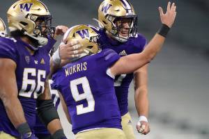 Washington quarterback Dylan Morris (9) celebrates with tight end Cade Otton, right, after Morris passed to Otton for a touchdown against Utah in the final minute of an NCAA college football game Saturday, Nov. 28, 2020, in Seattle. Washington won 24-21. (AP Photo/Ted S. Warren)