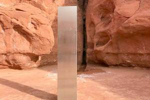 FILE - This Nov. 18, 2020, file photo provided by the Utah Department of Public Safety shows a metal monolith in the ground in a remote area of red rock in Utah. The mysterious silver monolith that was placed in the Utah desert has disappeared less than 10 days after it was spotted by wildlife biologists performing a helicopter survey of bighorn sheep, federal officials and witnesses said. The Bureau of Land Management said it had received credible reports that the three-sided stainless steel structure was removed on Nov. 27.  (Utah Department of Public Safety via AP, File)