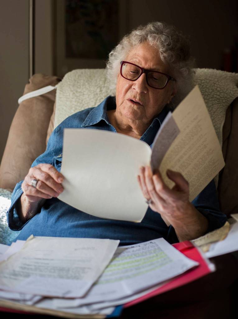 Janet Taggart flips through old documents related to the work she did to change the public education system to include students with disabilities. (Olivia Vanni / The Herald)