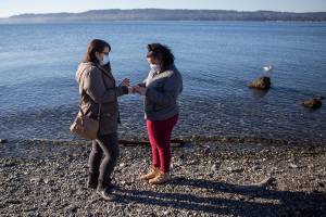 Jessica Parsons, left, and Little Sister Aliyah Velasquez, 13, walk along Mukilteo Beach during one of their Big Sister Little Sister hangouts on Wednesday, Dec. 2, 2020 in Mukilteo, Wa. (Olivia Vanni / The Herald)