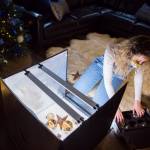 Sofia Drogomiretskiy prepares ornaments for a product photo to be posted to the internet. (Olivia Vanni / The Herald)