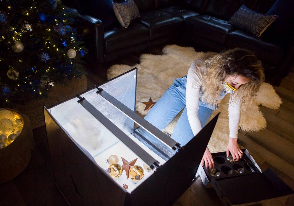 Sofia Drogomiretskiy prepares ornaments for a product photo to be posted to the internet. (Olivia Vanni / The Herald)