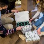 Sofia Drogomiretskiy and her husband, Stan Mykhaylenko, with Decorent ornament boxes. (Olivia Vanni / The Herald)
