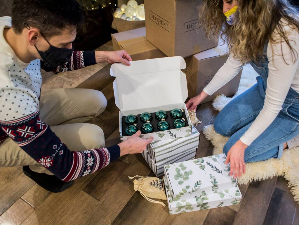 Sofia Drogomiretskiy and her husband, Stan Mykhaylenko, with Decorent ornament boxes. (Olivia Vanni / The Herald)