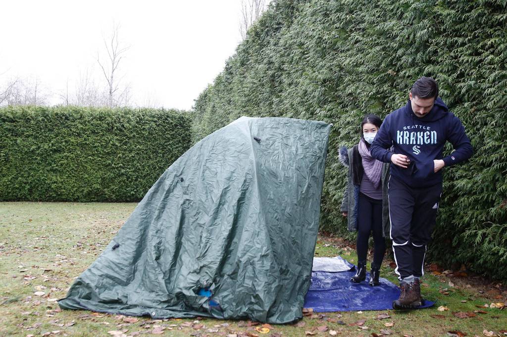 Even when the weather turns sour, Bobby Warwick and Sarah Foo spend as much time as they can at their tarp tent each week. (Kevin Clark / The Herald)