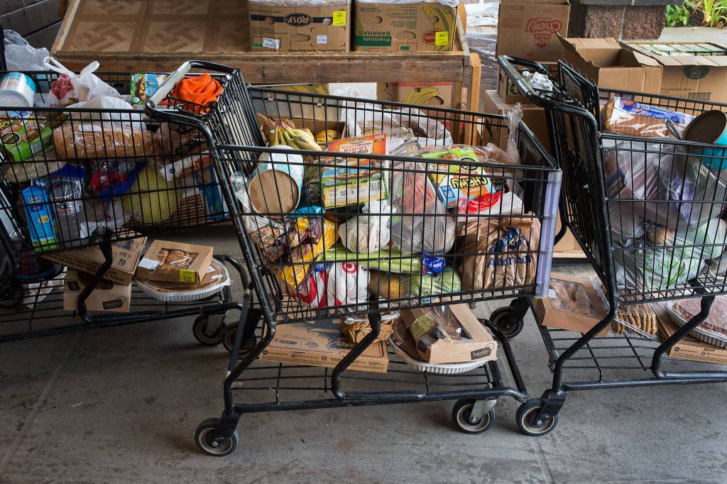 Shopping carts full of food wait to be delivered to those in need at the Marysville Community Food Bank on Nov. 30. (Andy Bronson / The Herald)