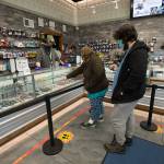Amethyst Skeels and Alexander Walsh pick out cannabis products at Kushmans Everett Cannabis Dispensary on Evergreen Way on Tuesday. (Andy Bronson / The Herald)