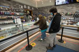 Amethyst Skeels and Alexander Walsh pick out cannabis products at Kushman's Everett Cannabis Dispensary on Evergreen Way on Tuesday, Dec. 1, 2020 in Everett, Washington.  (Andy Bronson / The Herald)