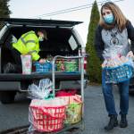 Sky Valley Food Bank Executive Director Cindy Chessie helps unload Jon Wilsons toy block donations on Wednesday in Monroe. (Olivia Vanni / The Herald)