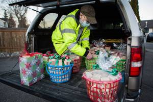 Jon Wilson, who handcrafted toy blocks, unloads wrapped wooden block baskets for donation to the Sky Valley Food Bank on Wednesday, Dec. 2, 2020 in Monroe, Wa. (Olivia Vanni / The Herald)