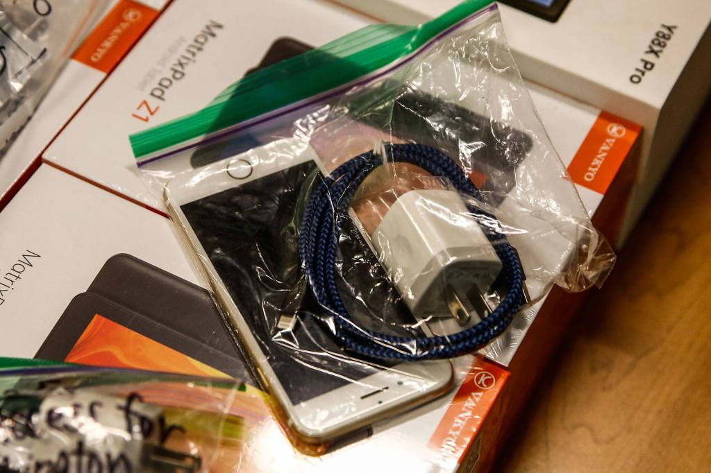 Donated and purchased devices are donated to Community Health Center for Telehealth Access for Seniors in Everett on Dec. 4. (Kevin Clark / The Herald)