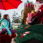 Callie Fosie, 11, talks to Santa Claus about seeing him in her house a few Christmases ago. They spoke during the socially distanced meet-up hosted by Maryfest on Thursday in Marysville. (Olivia Vanni / The Herald)