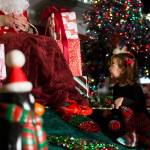 Emily Hatley, 5, smiles at Santa Claus during the socially distanced meet-up hosted by Maryfest on Thursday in Marysville. (Olivia Vanni / The Herald)