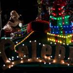 People take photographs with Santa Claus, who is set up on a festival float, Thursday in Marysville. (Olivia Vanni / The Herald)