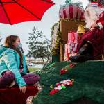 Callie Fosie, 11, talks to Santa Claus about seeing him in her house a few Christmases ago during the socially distanced meet up hosted by Maryfest on Thursday, Dec. 17, 2020 in Marysville, Wa. (Olivia Vanni / The Herald)