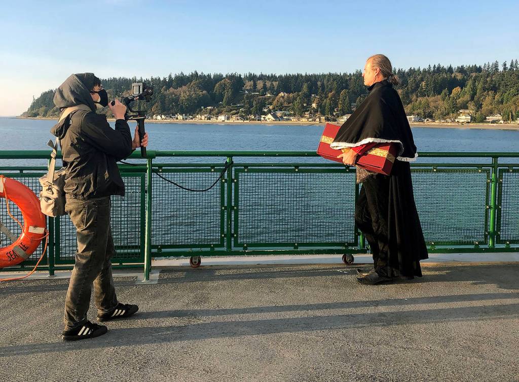 Videographer Nick Dubesa shoots a Nutcracker scene with Uncle Drosselmeyer, played by Lars Larsen, on the Mukilteo-Clinton ferry. (Grace Swanson)