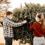 Caleb Sanders and Ashley Dougherty help decorate for the Trees of Christmas event at the Everett Bible Baptist Church. (Maria Lara)