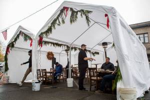 The Oxford Saloon owner Craig Swanson takes the orders of customers dinning outdoors along First Street on Wednesday, Dec. 9, 2020 in Snohomish, Wa. (Olivia Vanni / The Herald)