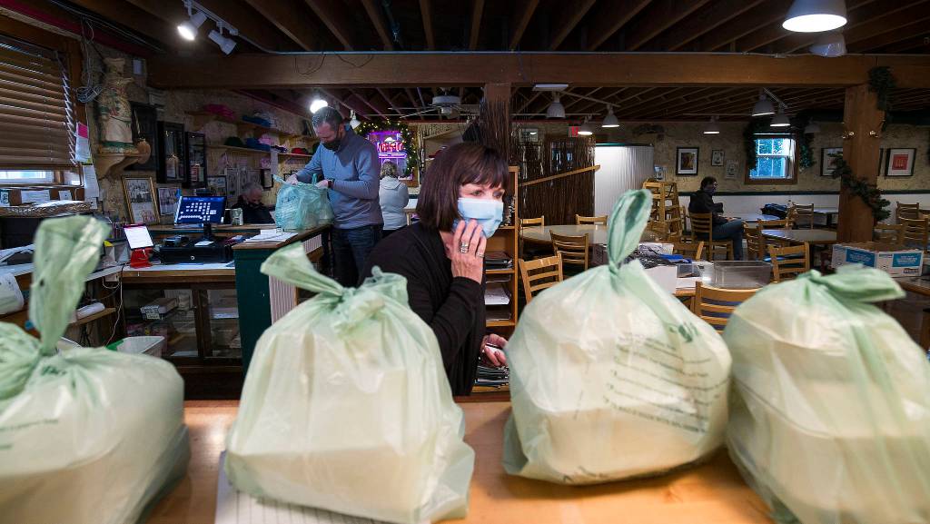 With a higher-than-normal number of orders on the counter, Sandra Albright looks for a customers order at the Maltby Cafe on Thursday. (Andy Bronson / The Herald)