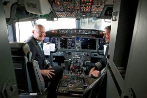 Pilots Peter Gamble, left, and John Konstanzer talk with journalists and crew members after flying a Boeing 737 Max from Dallas and arriving at the American Airlines Tulsa maintenance facility Wednesday, Dec. 2, 2020 in Tulsa, Okla.. Earlier the plane had flown a group of journalists and American Airlines employees from Dallas to the American Airlines Tulsa maintenance facility. (Mike Simons/Tulsa World via AP)