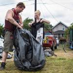 Jack Travis gets help packing up his tent at the Rucker Avenue homeless camp on Thursday, July 9, 2020 in Everett, Wa. (Olivia Vanni / The Herald)