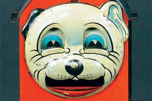 To deposit a coin in the Bonzo bank, you had to push his tummy. His tongue would come out of his mouth to deposit the coin inside. Many similar banks were made picturing other comic characters. (Cowles Syndicate Inc.)