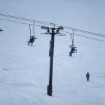 People ride one person to a chair on opening day at Stevens Pass last Friday. (Olivia Vanni / The Herald)