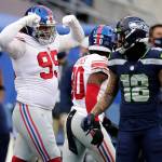New York Giants defensive end Leonard Williams (left) reacts next to Seattle Seahawks wide receiver Freddie Swain (18) after a play during the second half of Sundays game in Seattle. (AP Photo/Larry Maurer)