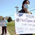Lindsey Weedston and Carrie F. protested the treatment of inmates outside the grounds of the Monroe Correctional Complex back in April. (Kevin Clark / Herald file)