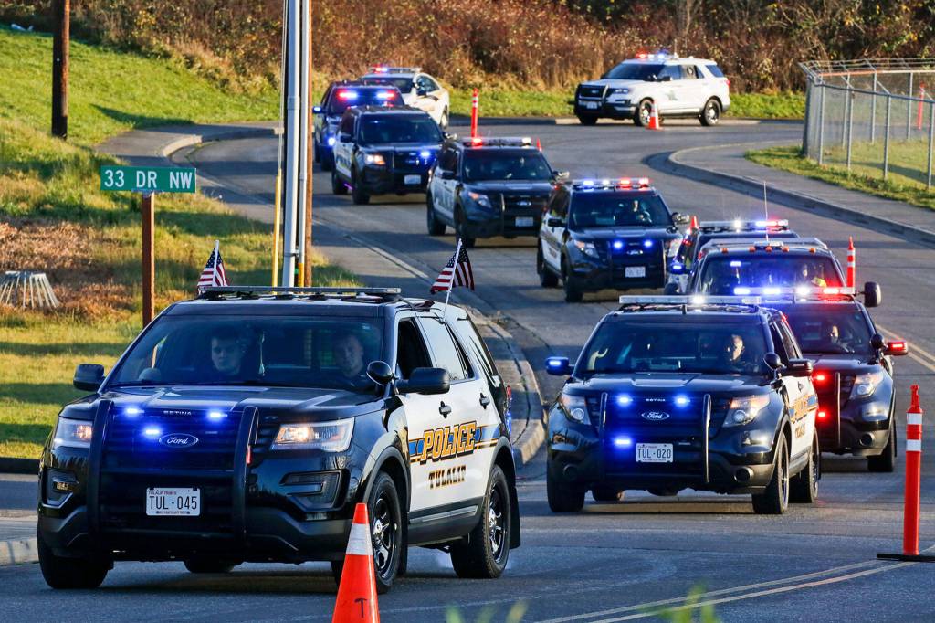 Law enforcement officers lead a memorial parade for missing Tulalip officer Charlie Cortez Saturday afternoon on the Tulalip Reservation. (Kevin Clark / The Herald)