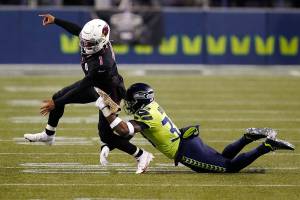 Seattle Seahawks strong safety Jamal Adams, right, gets to Arizona Cardinals quarterback Kyler Murray (1) just as Murray gets a pass off, during the second half of an NFL football game, Thursday, Nov. 19, 2020, in Seattle. (AP Photo/Elaine Thompson)