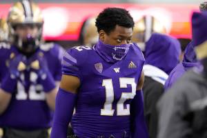 Washington defensive back Jacobe Covington wears a mask on the sideline against Oregon State during an NCAA college football game, Saturday, Nov. 14, 2020, in Seattle. (AP Photo/Ted S. Warren)