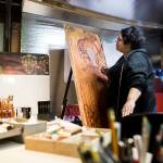 Lu Hernandez works in her studio, in the garage of her Everett home. (Olivia Vanni / The Herald)