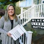 Rep. Tarra Simmons, D-Bremerton, holds blank voter registration forms as she poses for a photo Dec. 9 at her home in Bremerton. Simmons, believed to be the first formerly incarcerated person to win election to the Statehouse, is now working to help restore voting rights to people in Washington state who are out on parole or probation after serving prison time. (AP Photo/Ted S. Warren)