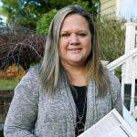 Rep. Tarra Simmons, D-Bremerton, holds blank voter registration forms as she poses for a photo Wednesday, Dec. 9, 2020, at her home in Bremerton, Wash. Simmons, believed to be the first formerly incarcerated person to win election to the Statehouse, is now working to help restore voting rights to people in Washington state who are out on parole or probation after serving prison time. (AP Photo/Ted S. Warren)