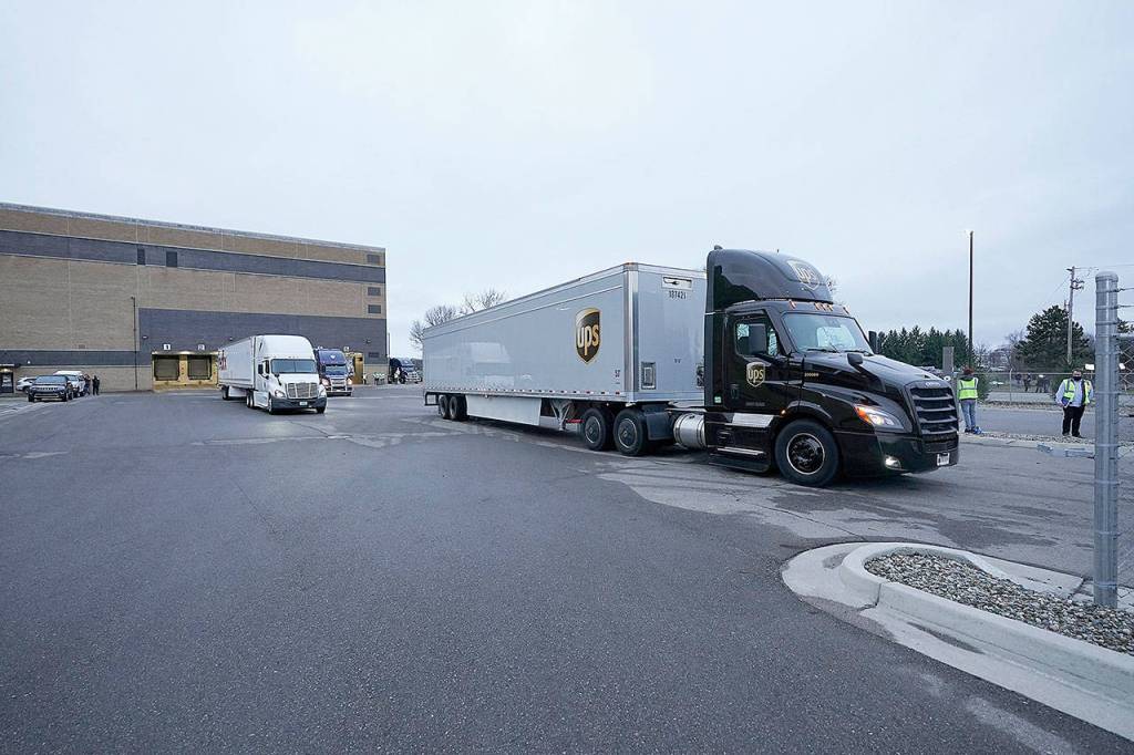 A truck loaded with the Pfizer-BioNTech COVID-19 vaccine leaves the Pfizer Global Supply Kalamazoo manufacturing plant Sunday in Portage, Mich. (AP Photo/Morry Gash, Pool)
