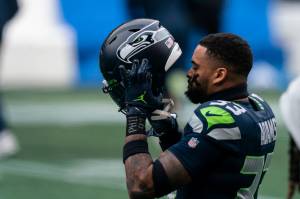Seattle Seahawks safety Jamal Adams puts on his helmet before Sundays game against the New York Jets at Lumen Field. Adams set the NFLs single-season record for sacks by a defensive back in Seattles 40-3 victory. (AP Photo/Stephen Brashear)