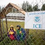 An ICE Detention Center sign hangs on the chain-link fence surrounding the Nativity scene in front of Edmonds Lutheran Church. (Olivia Vanni / The Herald)
