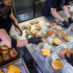 Meals for the Everett Gospel Mission are assembled Thursday at the Vintage Cafe in Everett. (Olivia Vanni / The Herald)