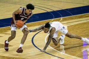 Washington's Nate Roberts, right, stumbles and loses his defensive posture on Montana's Kyle Owens in the first half of an NCAA college basketball game, Wednesday, Dec. 16, 2020, at Alaska Airlines Arena in Seattle. (Dean Rutz/The Seattle Times via AP)