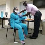 Nurse Elizabeth Njie is vaccinated at Providence Regional Medical Center Everett on Friday. (Providence)