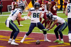 Seattle Seahawks tight end Jacob Hollister (86) celebrates his touchdown with teammates Colby Parkinson (84) and Tyler Lockett (16) during the first half against the Washington Football Team on Sunday at FedEx Field. (AP Photo/Andrew Harnik)