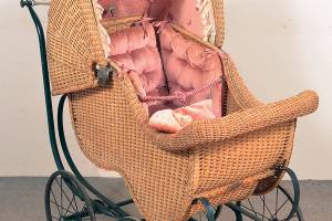 The 44-inch-tall antique wicker carriage has an adjustable hood. It auctioned for just $61.50 at a Conestoga Auction Co. sale. (Cowles Syndicate Inc.)