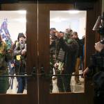 Protesters try to get into the Oregon State Capitol during a special session of the state legislature in Salem, Ore., on Monday, Dec. 21, 2020. State police declared an unlawful assembly at Oregon’s Capitol building as protesters opposed to COVID-19 restrictions attempted to force their way in during the third special legislative session. (Abigail Dollins/Statesman-Journal via AP)