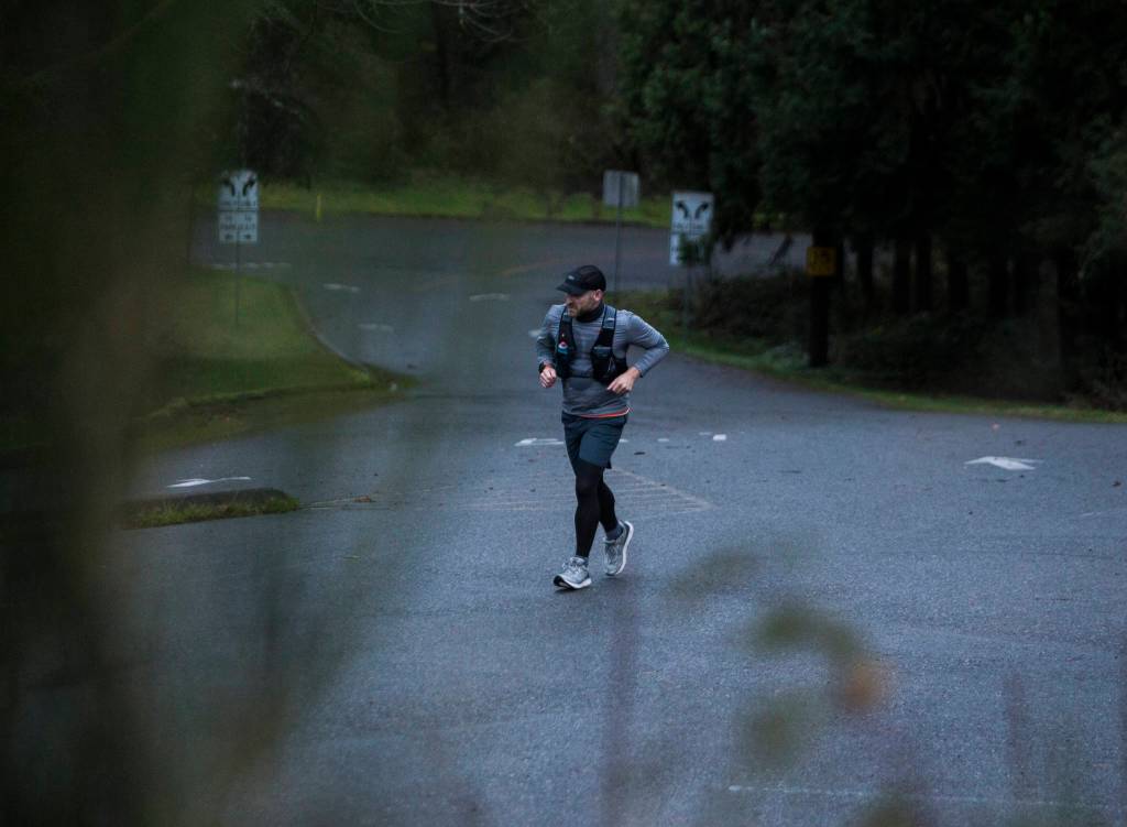 Wes Plate make this way up the hill into Forest Park on Sunday, Dec. 20, 2020 in Everett. (Olivia Vanni / The Herald)