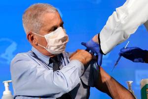 Dr. Anthony Fauci, director of the National Institute of Allergy and Infectious Diseases, prepares to receive his first dose of the COVID-19 vaccine at the National Institutes of Health, Tuesday, Dec. 22, 2020, in Bethesda, Md. (AP Photo/Patrick Semansky, Pool)