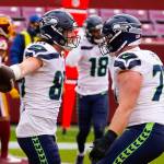 Seahawks tight end Jacob Hollister (left) celebrates his touchdown with center Ethan Pocic (right) during the first half of a game against Washington on Dec. 20, 2020, in Landover, Md. (AP Photo/Andrew Harnik)